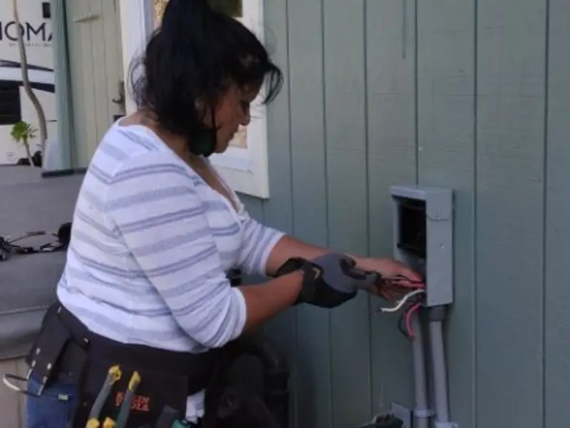 Licensed electrician wiring an exterior subpanel in Bridge City